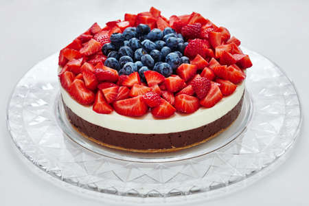 Strawberry-grape cheesecake on white backgroundの写真素材