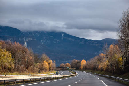 Asphalt Road At The Foot Of The Alps Mountainsの写真素材