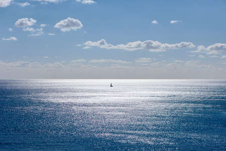 Single yacht sailing on opened seaの写真素材