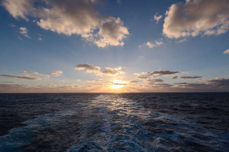 dramatic clouds sea sunset with sunraysの写真素材