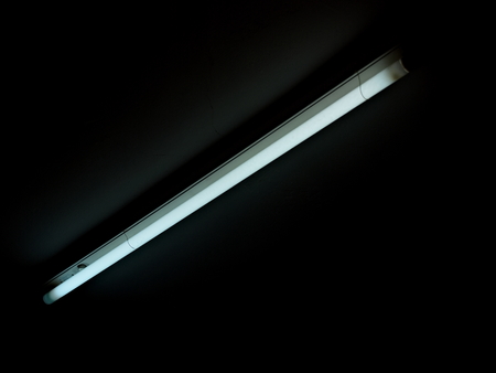 Fluorescent Lamp. Daylight lamp. Light in the dark.の写真素材