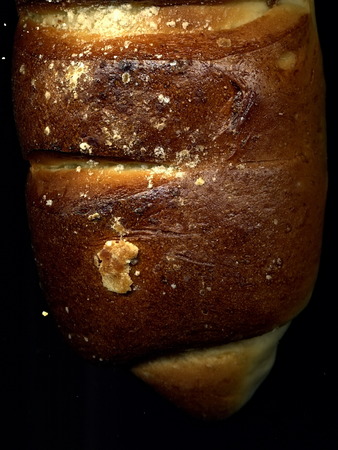 Baton. A sweet bun. Delicious roll of macro. Texture of rolls. Texture of bread