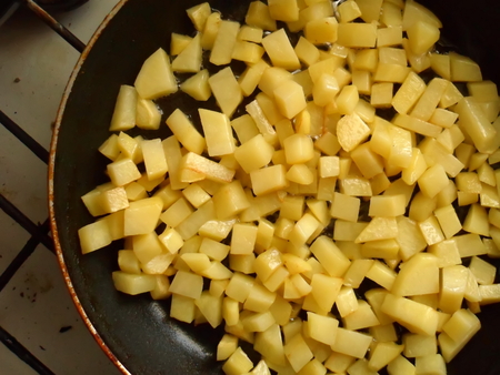 Fried potatoes in a frying pan.の写真素材