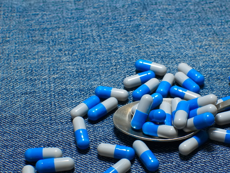 Spilled pills on the tableの写真素材