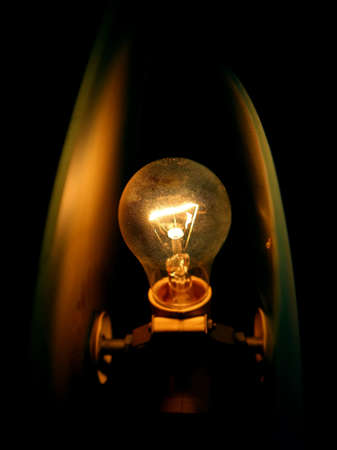 Ceiling lamp glowing in the black backgroundの写真素材