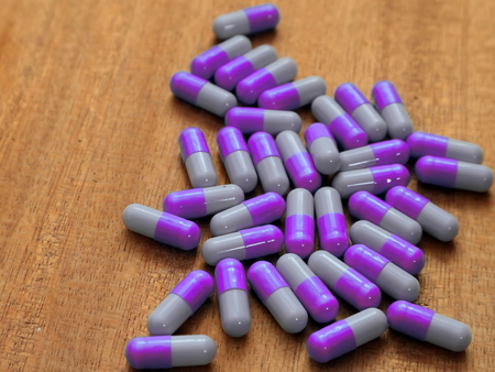 Spilled pills. Spilled tablets in capsules on the tableの写真素材