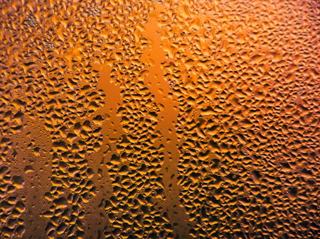 Drops of water on a cold glass. Condensate on glassの写真素材