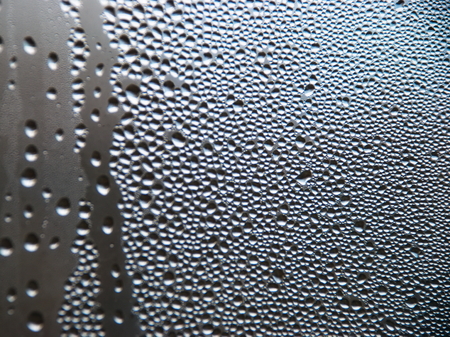 Drops of water on a cold glass. Condensate on glassの写真素材