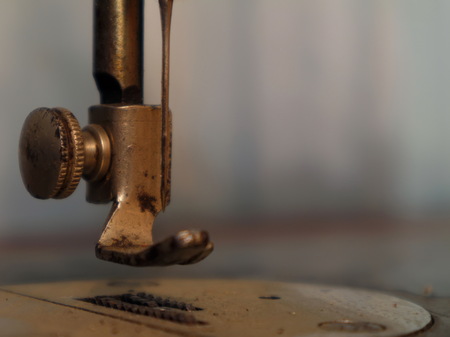 Old vintage sewing machine. Presser foot of an old sewing machine. Vintage. Closeup.