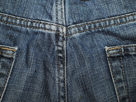 Old faded blue jeans. Macro. Pocket on old blue jeans. Blue jeans