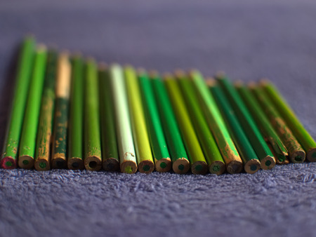 Colour pencils. Color pencils on a purple plaid. Green pencilsの写真素材