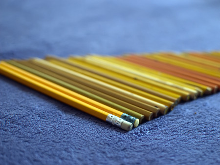 Colour pencils. Color pencils on a purple plaid. Yellow pencils