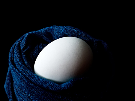 The egg lies in a scarf. Easter. Eggs in colored scarves.