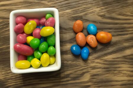 Multicolored round candy lying on the burlap. Multi-colored candies dragee. Small round candyの写真素材