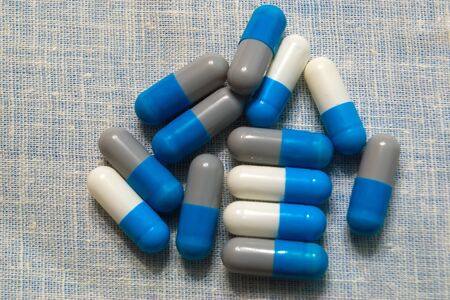Multi-colored pills on a table. Multi-colored round pills.の写真素材