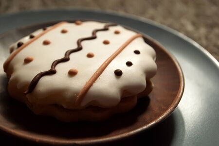 Cookies with white icing and wavy ornament. A cookie with an ornament. Tasty cookie.