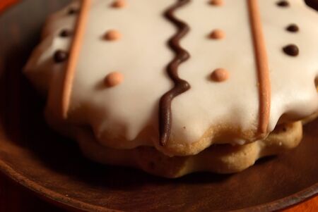Cookies with white icing and wavy ornament. A cookie with an ornament. Tasty cookie.