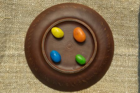 Multi-colored sweets on a clay plate. Colored candies on a plate.の写真素材