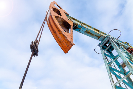 Mining and quarrying. Installations for the extraction of oil from the bowels of the Earth. Pumpjack is the overground drive for a reciprocating piston pump in an oil well.の写真素材