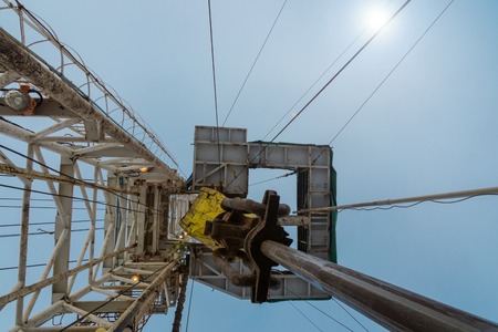 Oil and Gas Drilling Rig onshore dessert with dramatic cloudscape. Oil drilling rig operation on the...