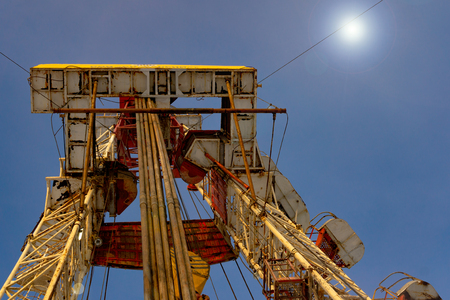 Oil and Gas Drilling Rig onshore dessert with dramatic cloudscape. Oil drilling rig operation on the oil platform in oil and gas industry. Land drilling rig blue skyの写真素材