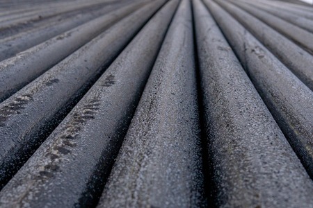 Offshore Industry oil and gas production petroleum pipeline. Downhole drilling rig. Laying the pipe on the deck. View of the shell of drill pipes laid in courtyard of the oil and gas warehouse.の写真素材