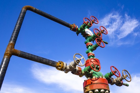 Horizontal view of a wellhead with valve armature. Oil and gas industry concept. Industrial site...