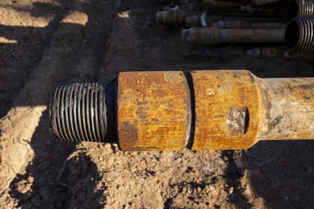 Oil Drill pipe. Rusty drill pipes were drilled in the well section. Downhole drilling rig. Laying...