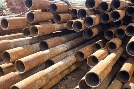 Oil Drill pipe. Rusty drill pipes were drilled in the well section. Downhole drilling rig. Laying...