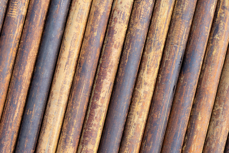 Rusty grunge pipes horizontal background. Orange corrosion rust on steel metal factory industrial pattern. Rough texture brown parallel stack close upの写真素材