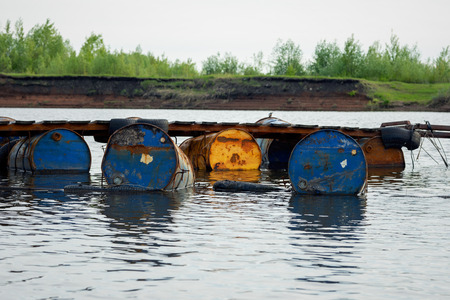 dumped oil drums cause pollution in the water, more and more the water is polluted by throwing away...