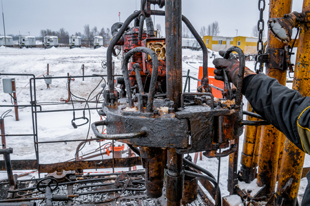 Workover rig working on a previously drilled well trying to restore production through repair. Toned.の写真素材