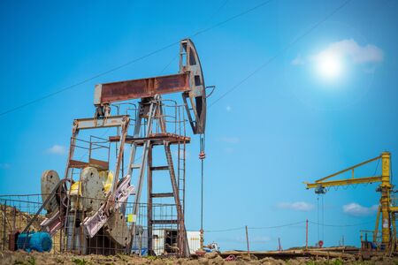 Oil pumpjack, industrial equipment. Rocking machines for power genertion. Extraction of oil.の写真素材