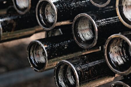 Drillpipe on Oil Rig Pipe Deck. Oil and gas industry. Work of oil pump jack on a oil fieldの写真素材