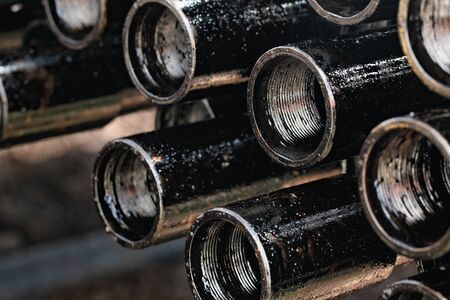 Drillpipe on Oil Rig Pipe Deck. Oil and gas industry. Work of oil pump jack on a oil field