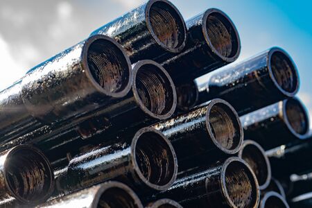 Drillpipe on Oil Rig Pipe Deck. Oil and gas industry. Work of oil pump jack on a oil field