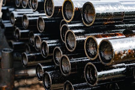 Drillpipe on Oil Rig Pipe Deck. Oil and gas industry. Work of oil pump jack on a oil fieldの写真素材