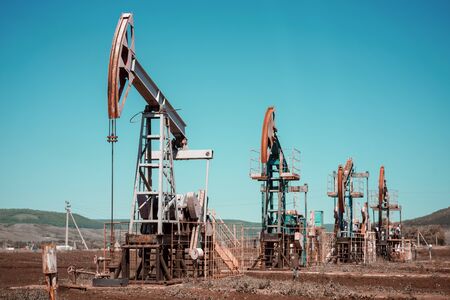 Oil pump jack rocking with pipeline in the background. Rocking machines for power generation. Extraction of oilの写真素材