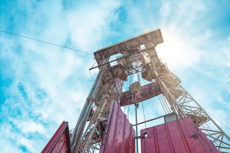 Oil and Gas Drilling Rig onshore dessert with dramatic cloudscape. Oil drilling rig operation on the oil platform in oil and gas industryの写真素材