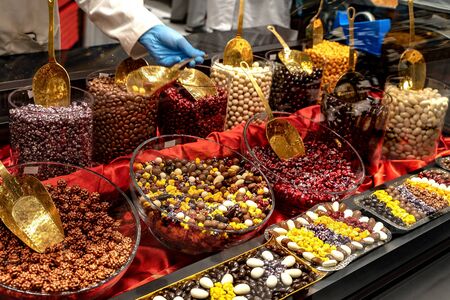 Chocolate truffles, candies and sweets store on showcase in factory store. Chocolate bit sized for sale in local chocolate store.の写真素材