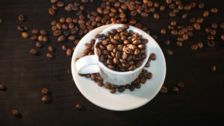 White Cup With Coffee Beans.