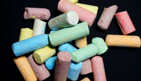 Colored chalks aligned on blackboardの写真素材