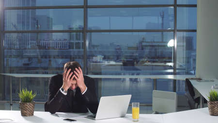 Serious man under stress at work.の写真素材
