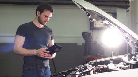 Auto mechanic service inspects current flow automobile and technical condition auto, diagnostics...