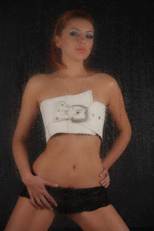 silhouette of a girl in lingerie for a wet glass