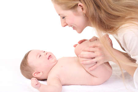 Baby massage. Mother massaging kid