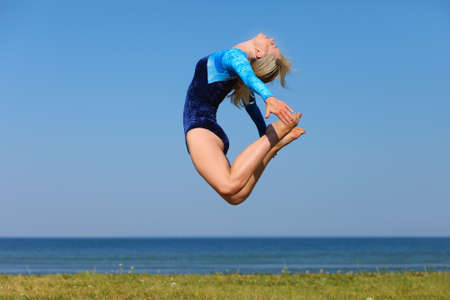 Young gymnast on seashoreの写真素材