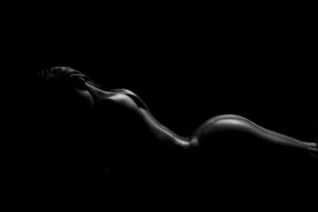 sexy silhouette of a naked female back and buttocksの写真素材