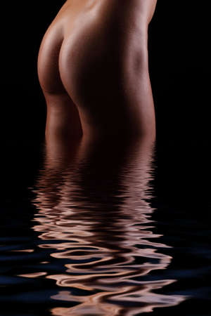 back and butt naked women.on a black backgroundの写真素材