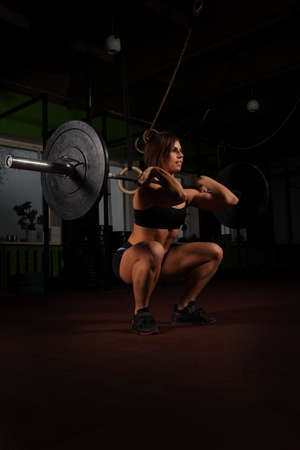 Woman lifting weight in gymの写真素材